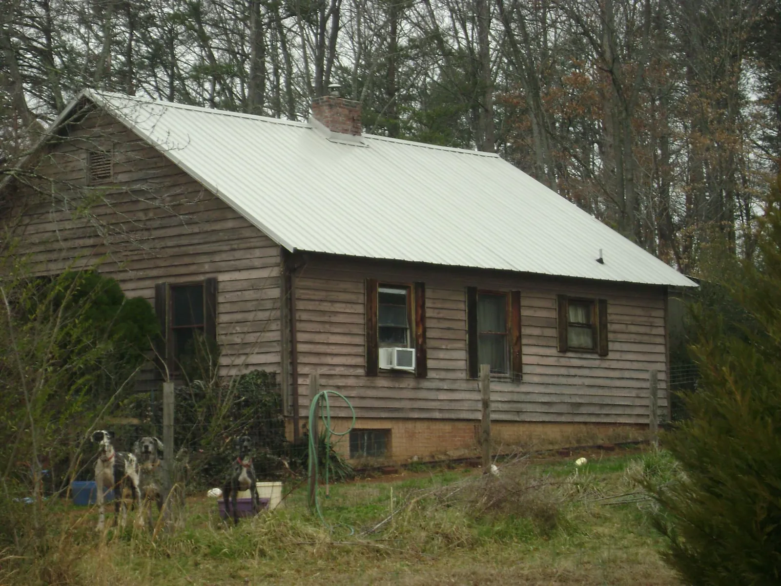 White metal roof on an old wood sided farmhouse, from a Metal Roof Installation job in Otis